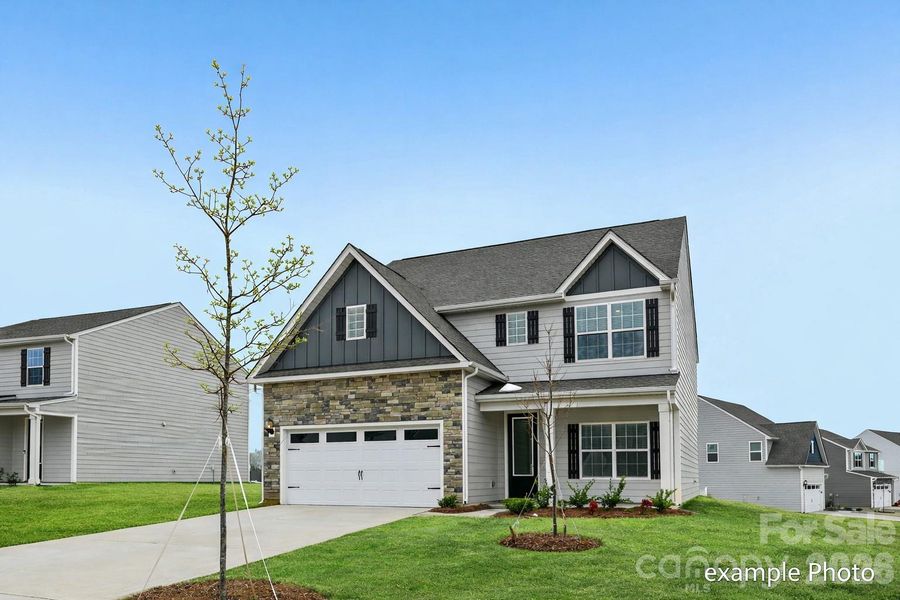 Front exterior of a new home in Colonial Crossing, Troutman, NC, highlighting curb appeal (Image 2). Front exterior of a new home in Colonial Crossing, Troutman, NC, highlighting curb appeal (Image 2).