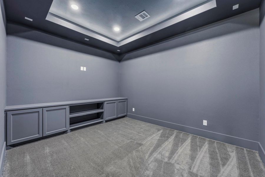 Private media room with built-ins ready for movie nights and entertainment.