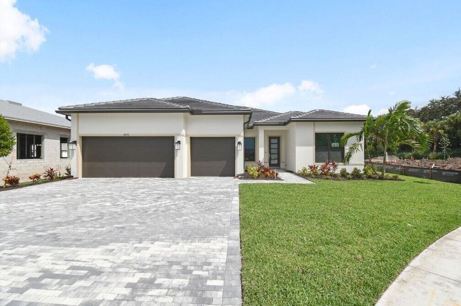 Front exterior of a new home in Greyhawk Landing, Lake Worth, FL, highlighting curb appeal (Image 2).