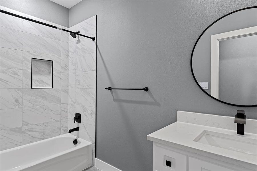 Full bathroom featuring a textured wall, bathing tub / shower combination, and vanity Full bathroom featuring a textured wall, bathing tub / shower combination, and vanity