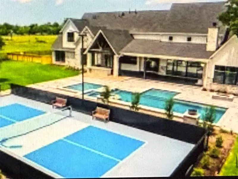 This is an inspirational photo of what the backyard "could" look like.  Imagine a sparkling pool and spa plus pickleball/tennis courts!