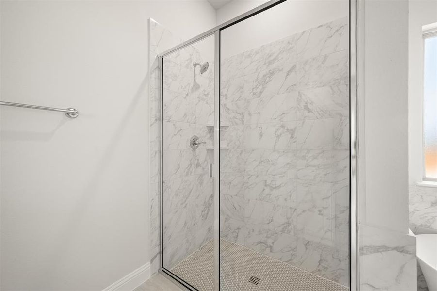 Full bathroom featuring a stall shower and a freestanding tub Full bathroom featuring a stall shower and a freestanding tub