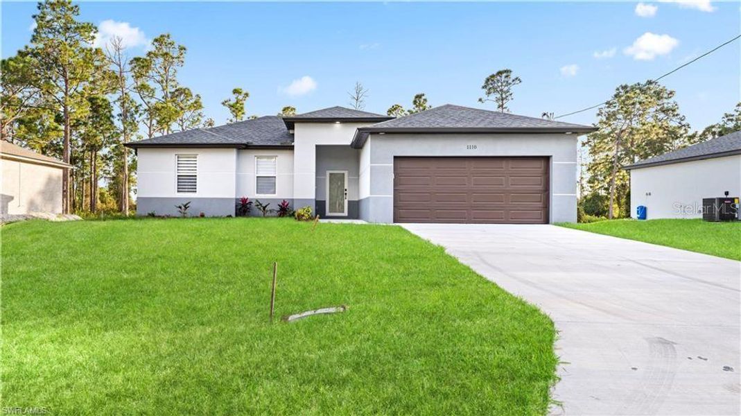Front exterior of a new home in , Lehigh Acres, FL, highlighting curb appeal (Image 23).