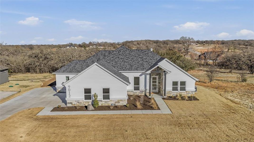 Front exterior of a new home in , Springtown, TX, highlighting curb appeal (Image 16).