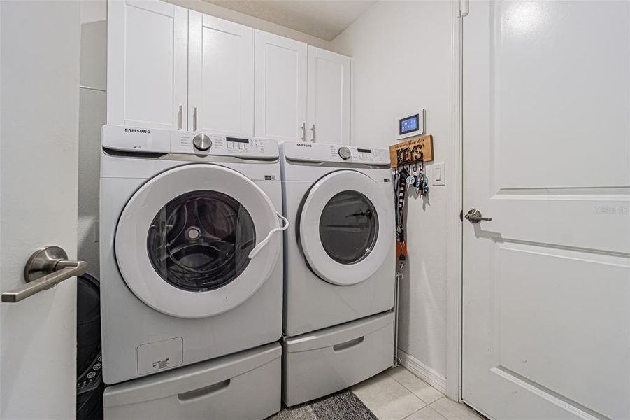 Spacious laundry room with shaker cabinets