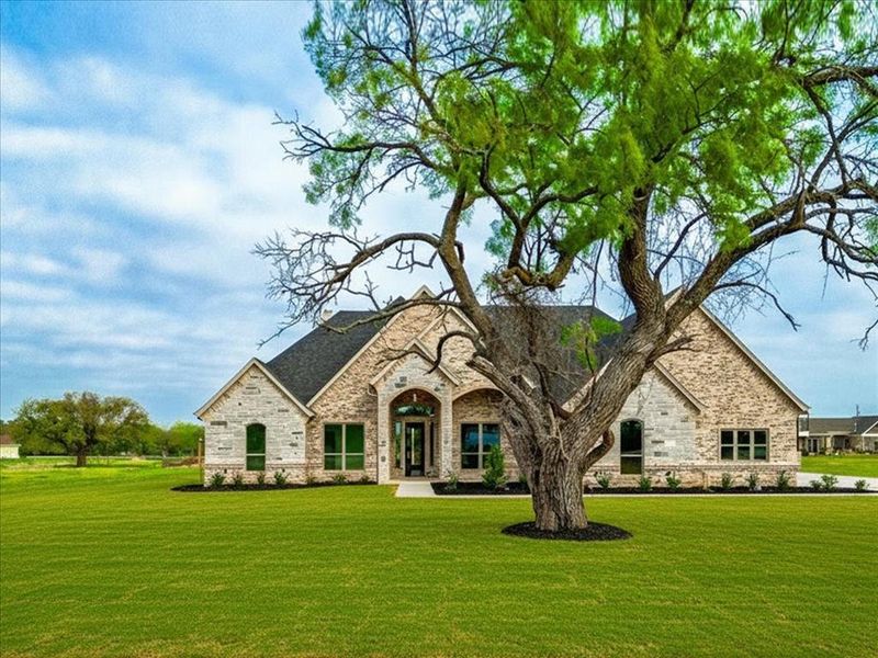 Front exterior of a new home in , Granbury, TX, highlighting curb appeal (Image 26). Front exterior of a new home in , Granbury, TX, highlighting curb appeal (Image 26).