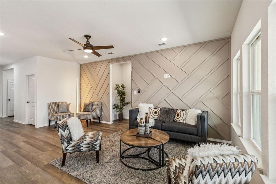 Living room with plenty of natural light, wood-type flooring, and ceiling fan