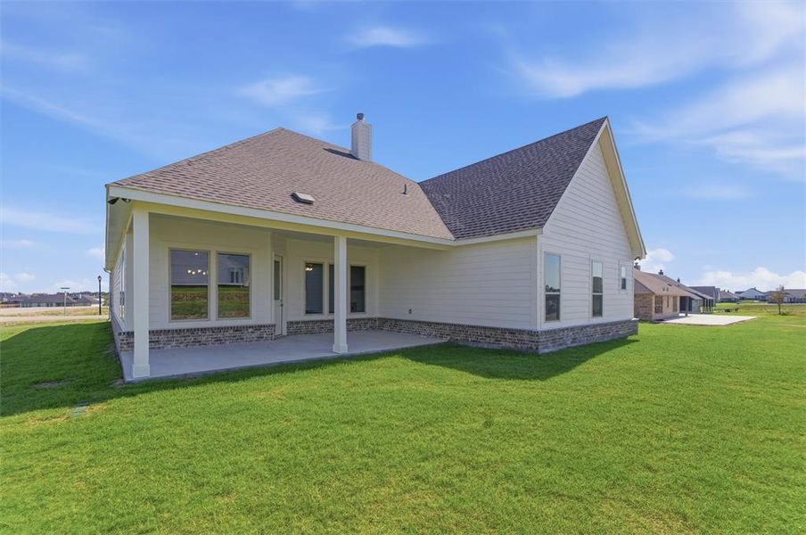 Expansive rear patio with covered outdoor space