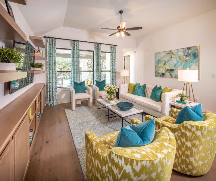 Living area featuring hardwood / wood-style flooring, a ceiling fan, and lofted ceiling