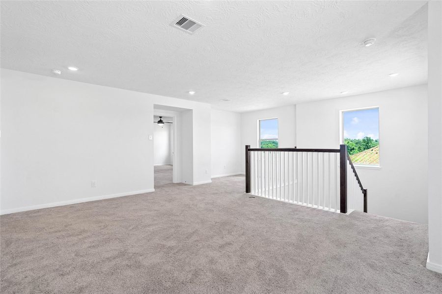 Additional view from game room looking into the primary bedroom.