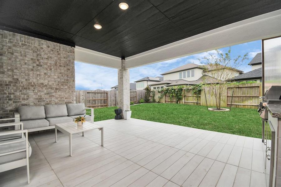 This backyard offers a spacious, well-maintained lawn perfect for outdoor activities and entertaining.