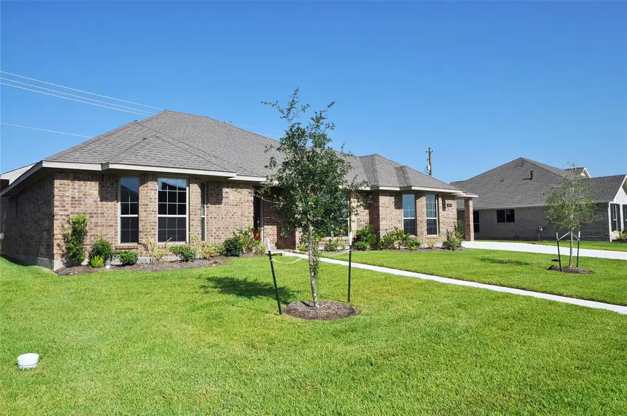 Front exterior of a new home in , League City, TX, highlighting curb appeal (Image 1). Front exterior of a new home in , League City, TX, highlighting curb appeal (Image 1).