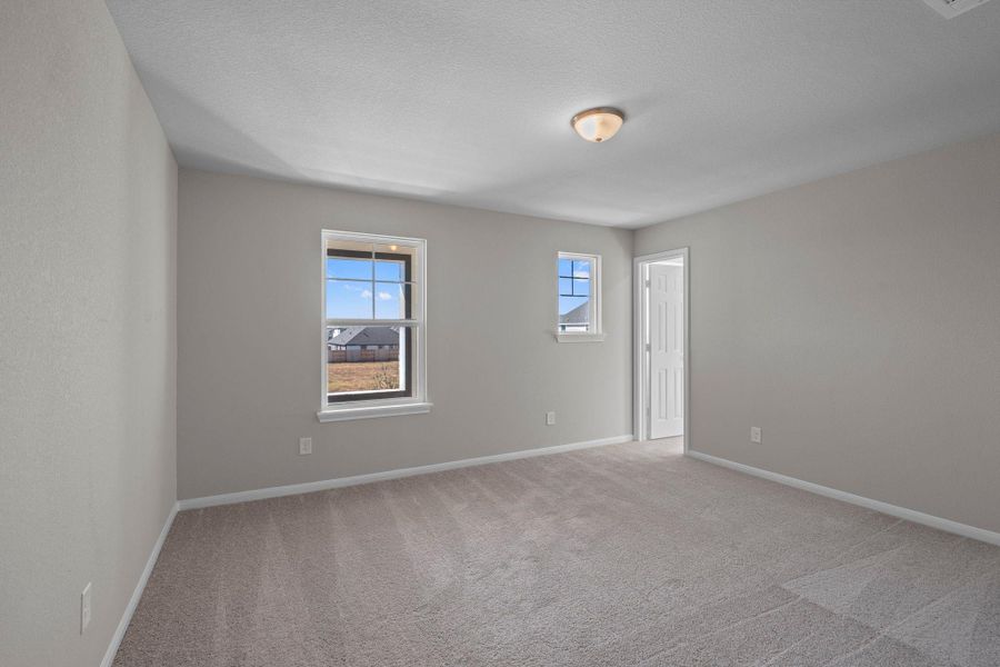 Your secondary bedroom features plush carpet, fresh paint, closet, and a large window that lets in plenty of natural lighting.