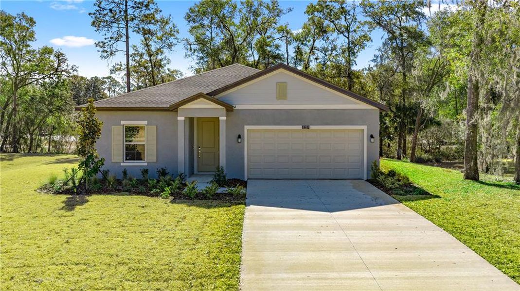 Front exterior of a new home in Grand Park, Dunnellon, FL, highlighting curb appeal (Image 1). Front exterior of a new home in Grand Park, Dunnellon, FL, highlighting curb appeal (Image 1).
