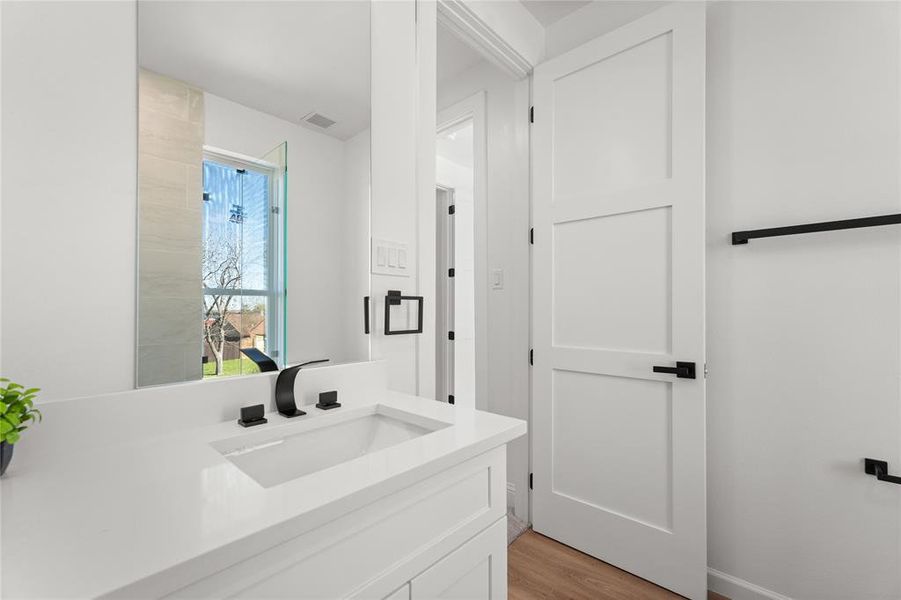 Bathroom featuring vanity and light wood finished floors