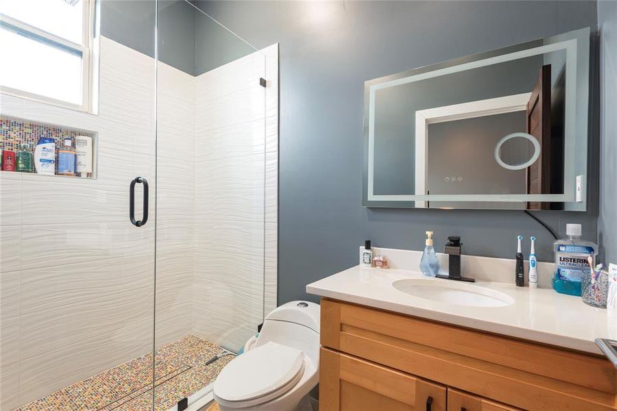 Bathroom with a stall shower and vanity Bathroom with a stall shower and vanity