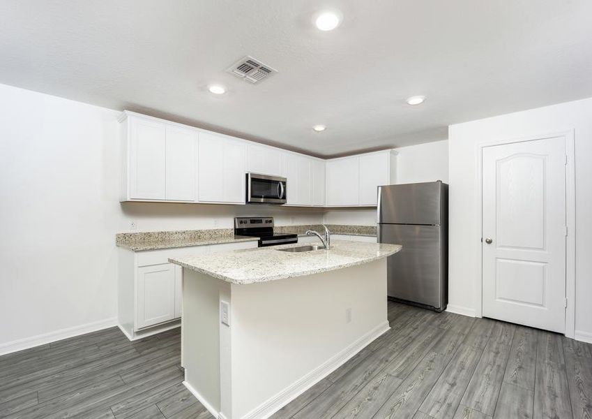 Kitchen with white cabinets, granite countertops and stainless steel appliances