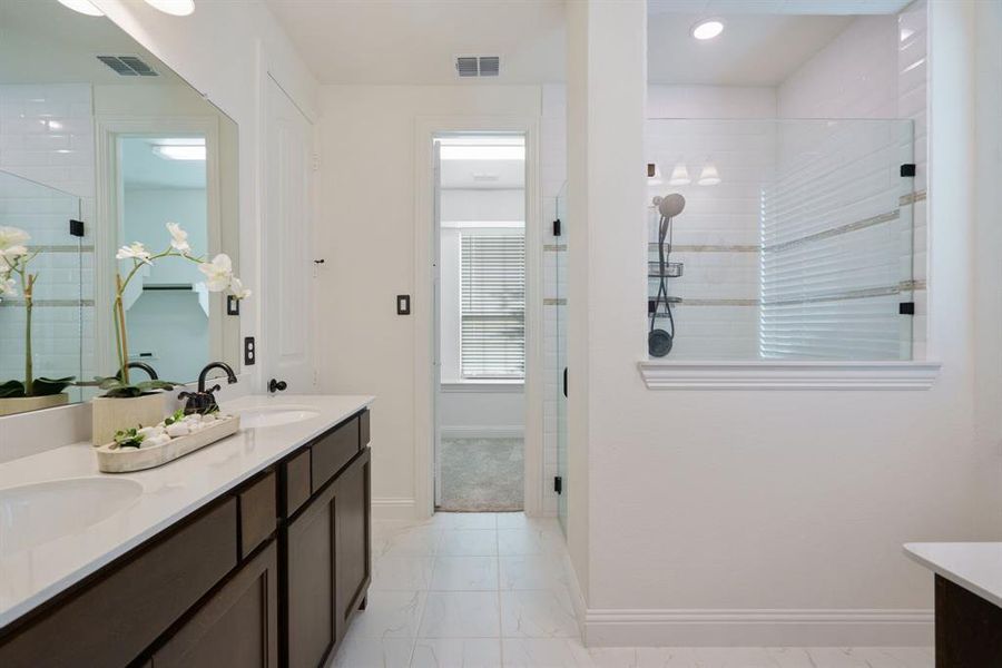 With double sinks, a spacious walk-in closet, and bonus cabinet space for a coffee bar, the primary bathroom has it all.