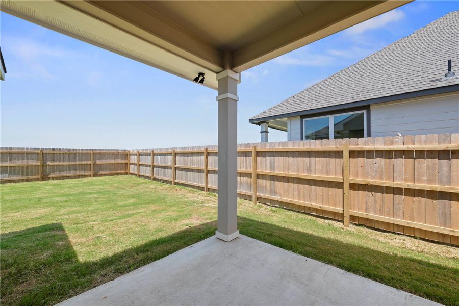 A spacious, enclosed yard features a covered patio, ideal for outdoor enjoyment. A spacious, enclosed yard features a covered patio, ideal for outdoor enjoyment.