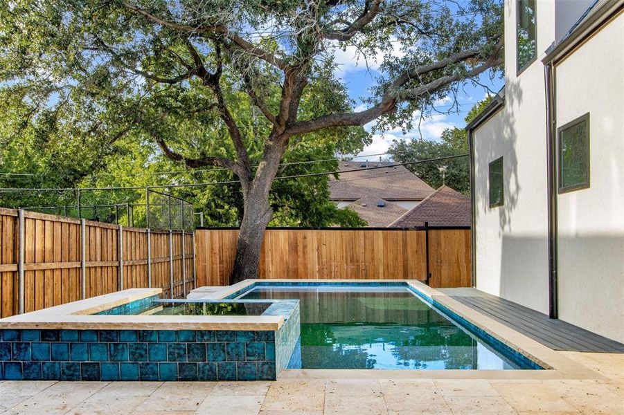 View of swimming pool with an in ground hot tub and a patio