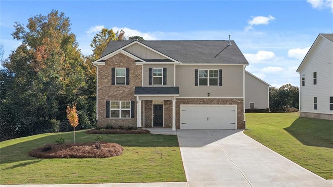 Front exterior of a new home in Bridle Creek, Locust Grove, GA, highlighting curb appeal (Image 1). Front exterior of a new home in Bridle Creek, Locust Grove, GA, highlighting curb appeal (Image 1).