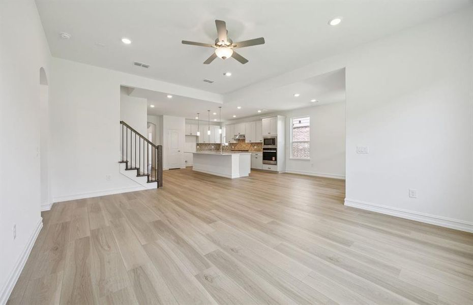 Open concept gathering room creating a spacious and inviting atmosphere *Real home pictured Open concept gathering room creating a spacious and inviting atmosphere *Real home pictured