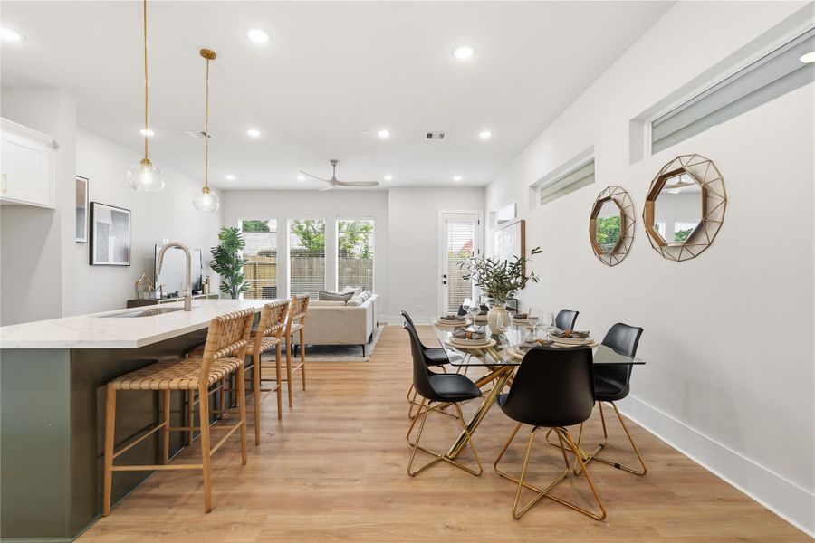 Designed for both everyday living and entertaining, the main floor balances openness with intention. A true dining space anchors the layout, while expansive windows and high ceilings create a light-filled, connected environment. Designed for both everyday living and entertaining, the main floor balances openness with intention. A true dining space anchors the layout, while expansive windows and high ceilings create a light-filled, connected environment.