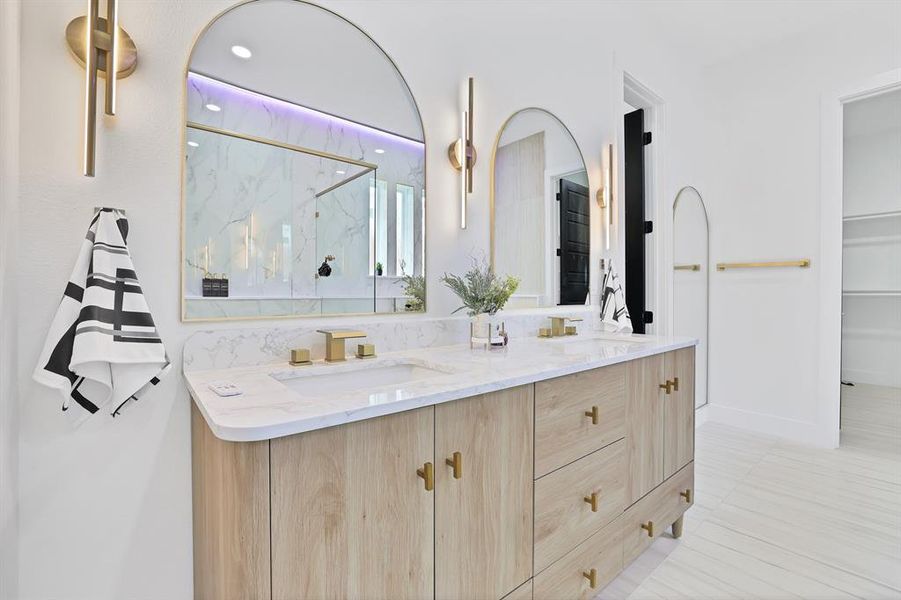 Bathroom with tile patterned floors, vanity, and walk in shower