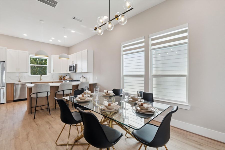 Designed for conversation and connection, the dining area is grounded by symmetry, scale, and soft illumination.