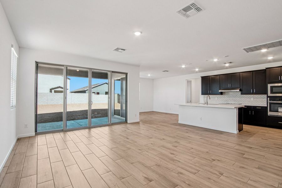 Great room, dining and kitchen. Finishes may vary by community.