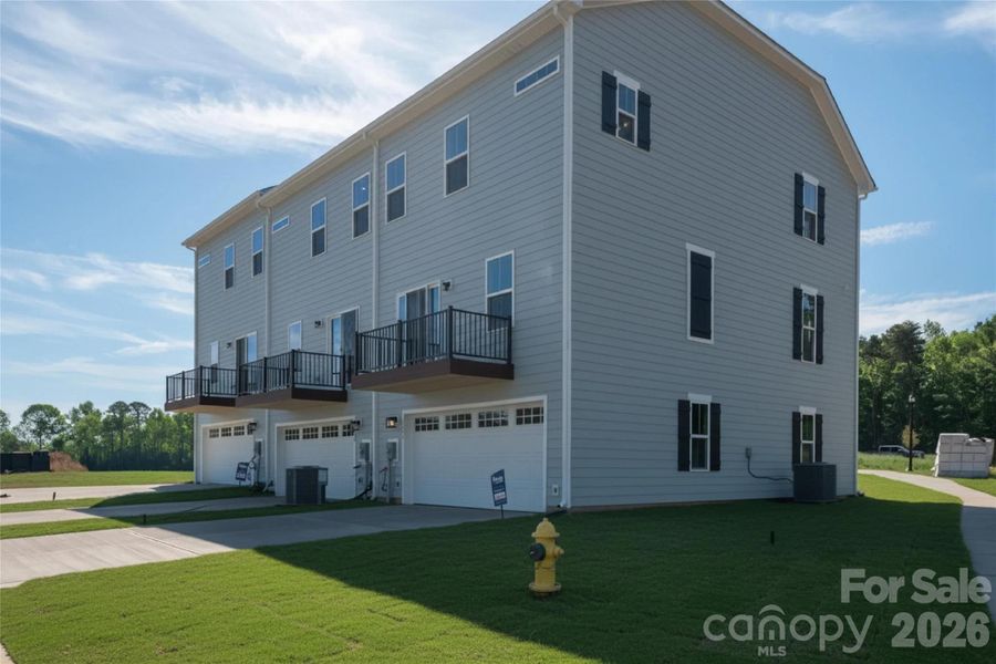 Exterior details and patio area of a home in Stowe Branch Townhomes, Charlotte (Image 3). Exterior details and patio area of a home in Stowe Branch Townhomes, Charlotte (Image 3).