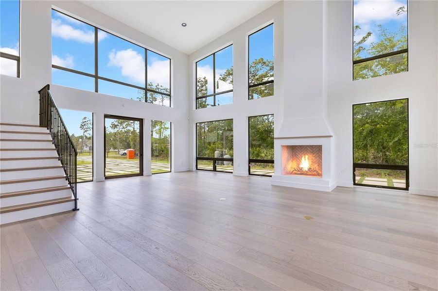 Front entry and living room with tons of natural light and volume ceilings