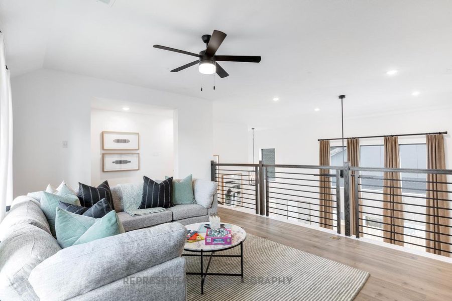 Living area featuring wood finished floors, ceiling fan, and recessed lighting Living area featuring wood finished floors, ceiling fan, and recessed lighting