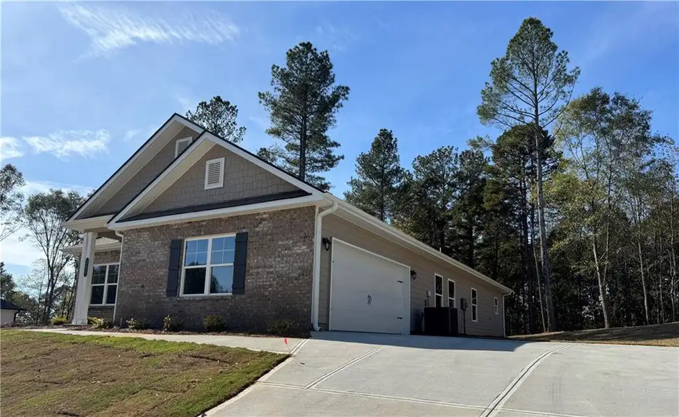Front exterior of a new home in The Fields of Walnut Creek, Pendergrass, GA, highlighting curb appeal (Image 1).