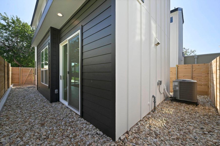 View of property exterior with a fenced backyard and a gate View of property exterior with a fenced backyard and a gate