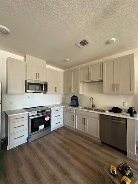 Kitchen featuring sink, dishwasher, stove,