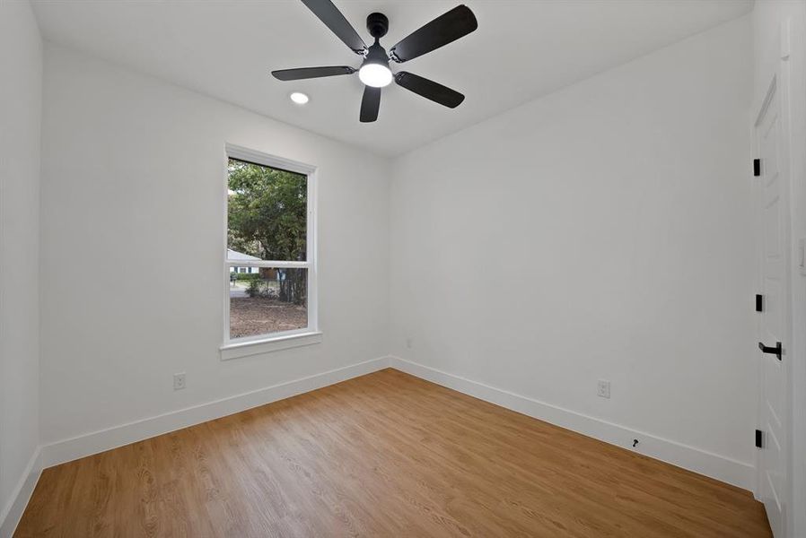 Spare room with light wood finished floors, recessed lighting, and ceiling fan