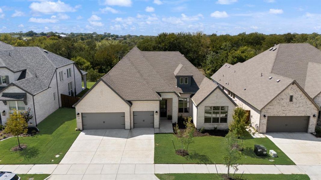 Front exterior of a new home in Monterra - Classics, Fate, TX, highlighting curb appeal (Image 2). Front exterior of a new home in Monterra - Classics, Fate, TX, highlighting curb appeal (Image 2).