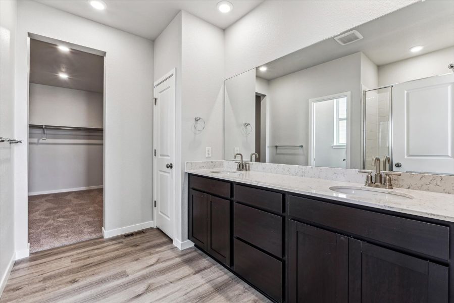 A bathroom with a large mirror.