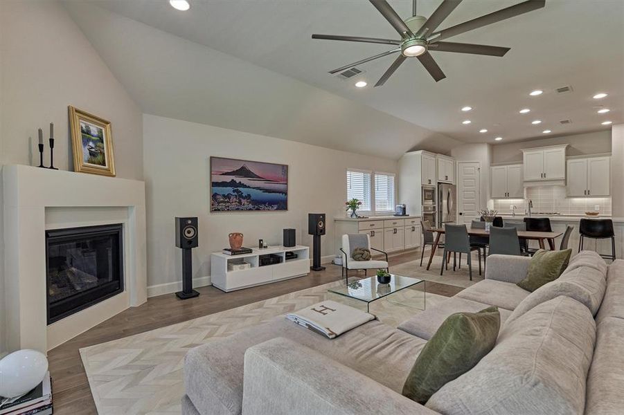 Gas log fireplace with sleek stone surround adds to the ambiance of this elegant space.