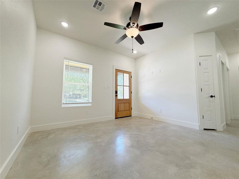 Empty room featuring concrete floors, a ceiling fan, visible vents, recessed lighting, and baseboards Empty room featuring concrete floors, a ceiling fan, visible vents, recessed lighting, and baseboards