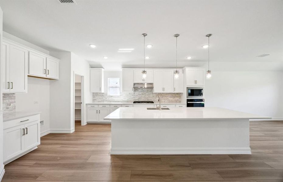 Kitchen featuring a large island ideal for informal dining and gatherings