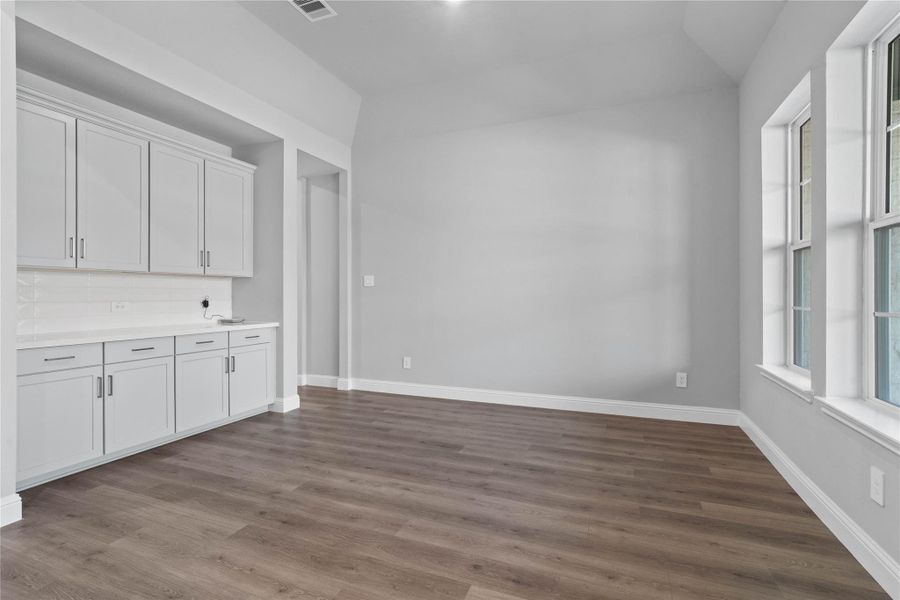 This elegant formal dining space is anchored by a sophisticated neutral palette and features a seamless transition to a fully equipped butler’s pantry, making it as functional for hosting large dinner parties as it is for intimate family gatherings.