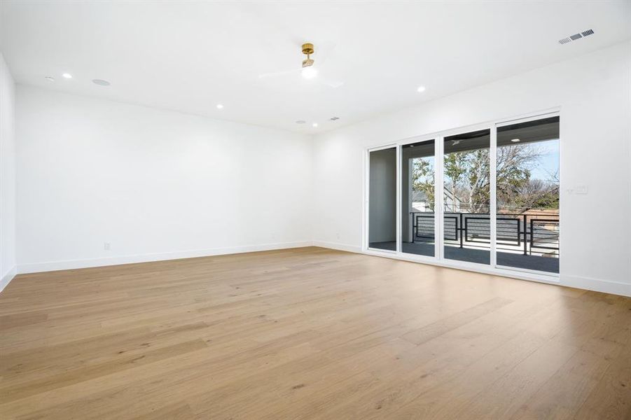 Unfurnished room with ceiling fan and light hardwood / wood-style flooring