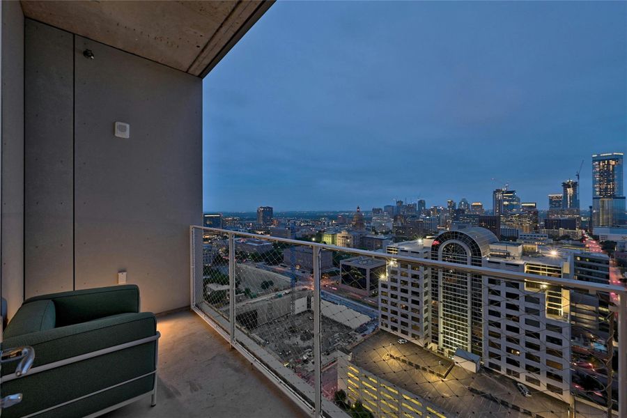 Private balcony with dramatic skyline views, perfect for evening relaxation and city lights. Photo is model unit #2406.