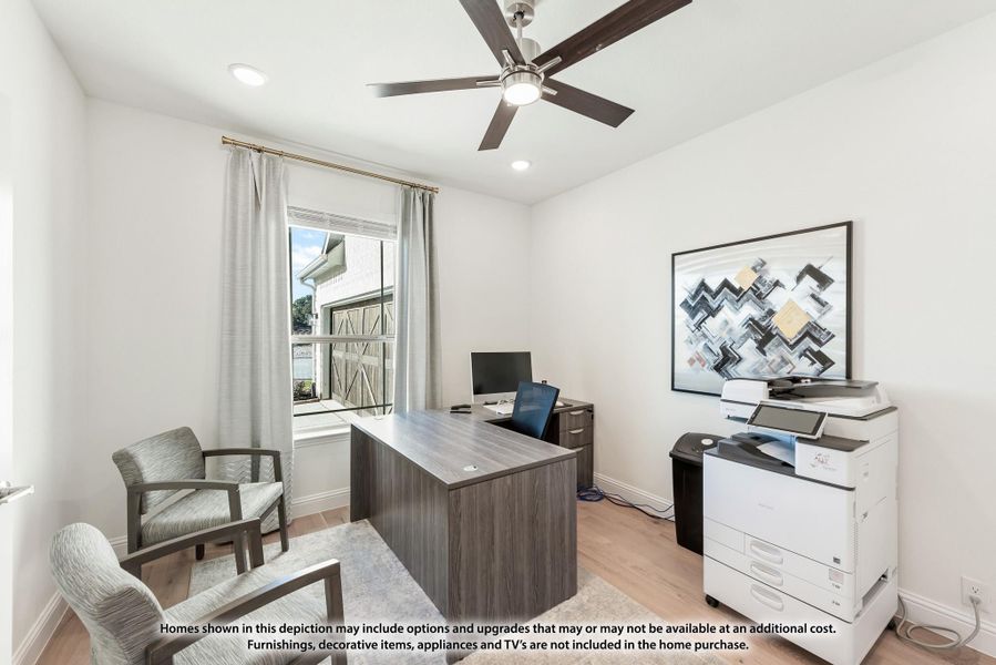 Home office with wood desk, ceiling fan, and hardwood floors with natural light from window Home office with wood desk, ceiling fan, and hardwood floors with natural light from window