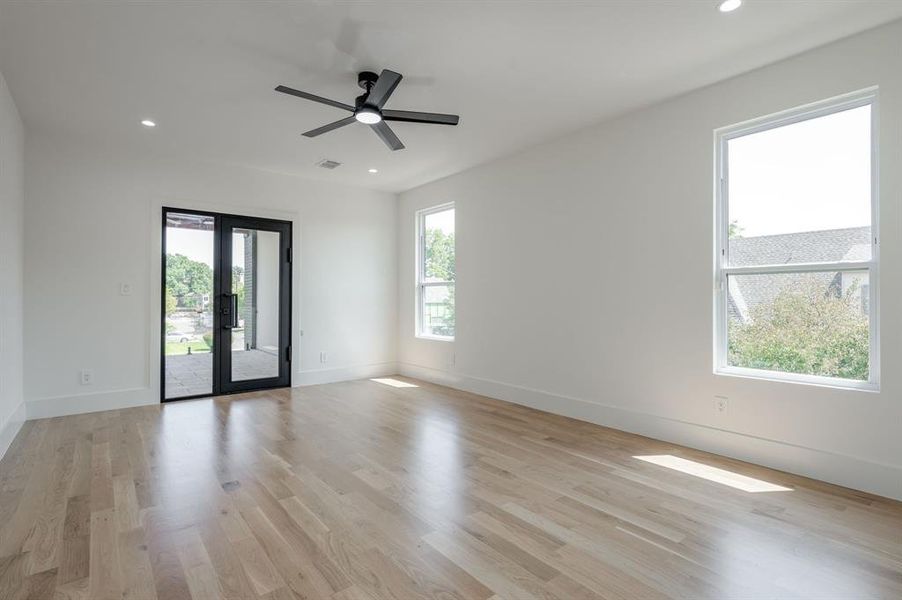 Spare room featuring light wood-style floors, recessed lighting, french doors, and ceiling fan Spare room featuring light wood-style floors, recessed lighting, french doors, and ceiling fan