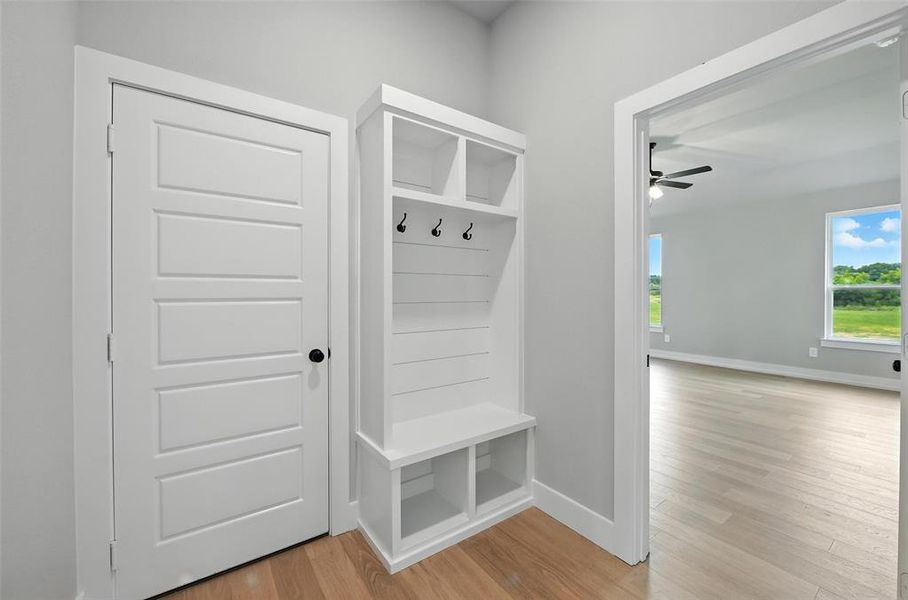 Mudroom featuring light wood-type flooring and ceiling fan Mudroom featuring light wood-type flooring and ceiling fan