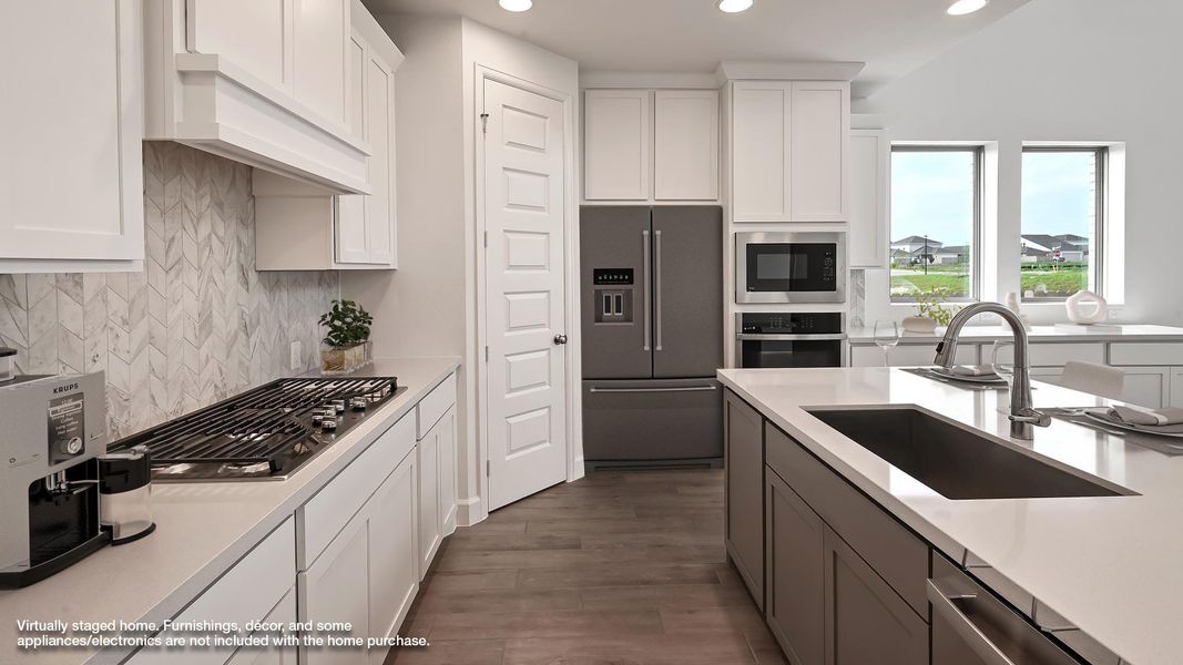 Kitchen with appliances with stainless steel finishes, light countertops, dark wood-style floors, recessed lighting, and white cabinetry