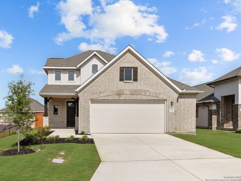 Front exterior of a new home in Megan's Landing, Castroville, TX, highlighting curb appeal (Image 13).